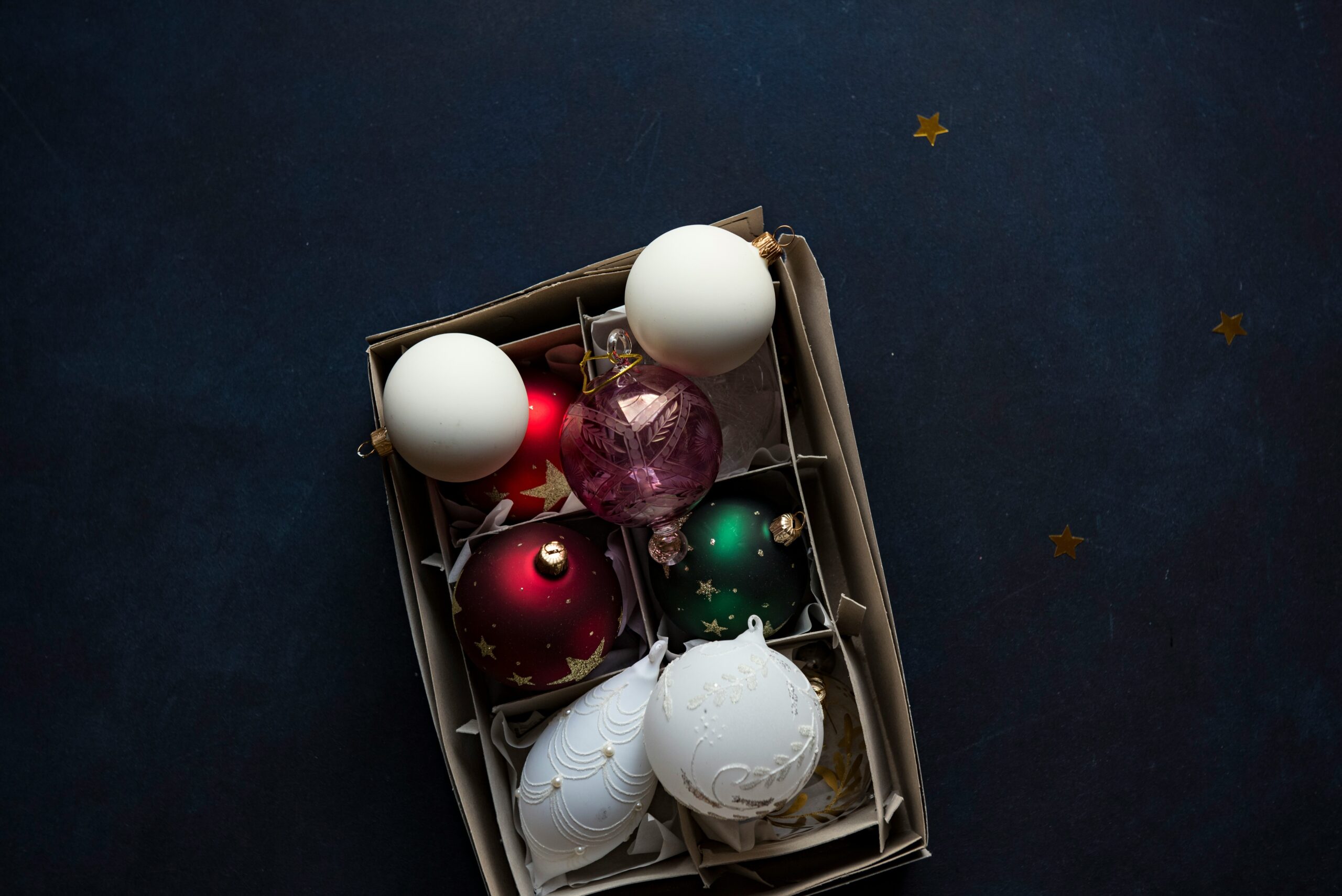 A beautifully arranged display of freshly cleaned, shining glass pet toys on a wooden countertop.