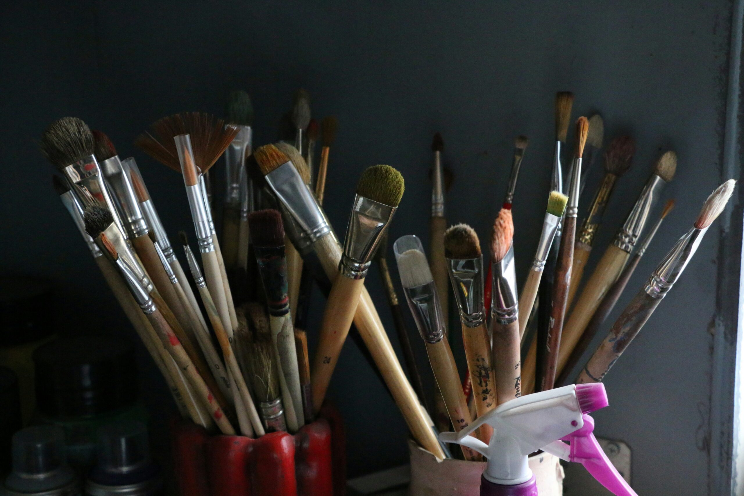 A collection of eco-friendly cleaning tools including vinegar, baking soda, and brushes.