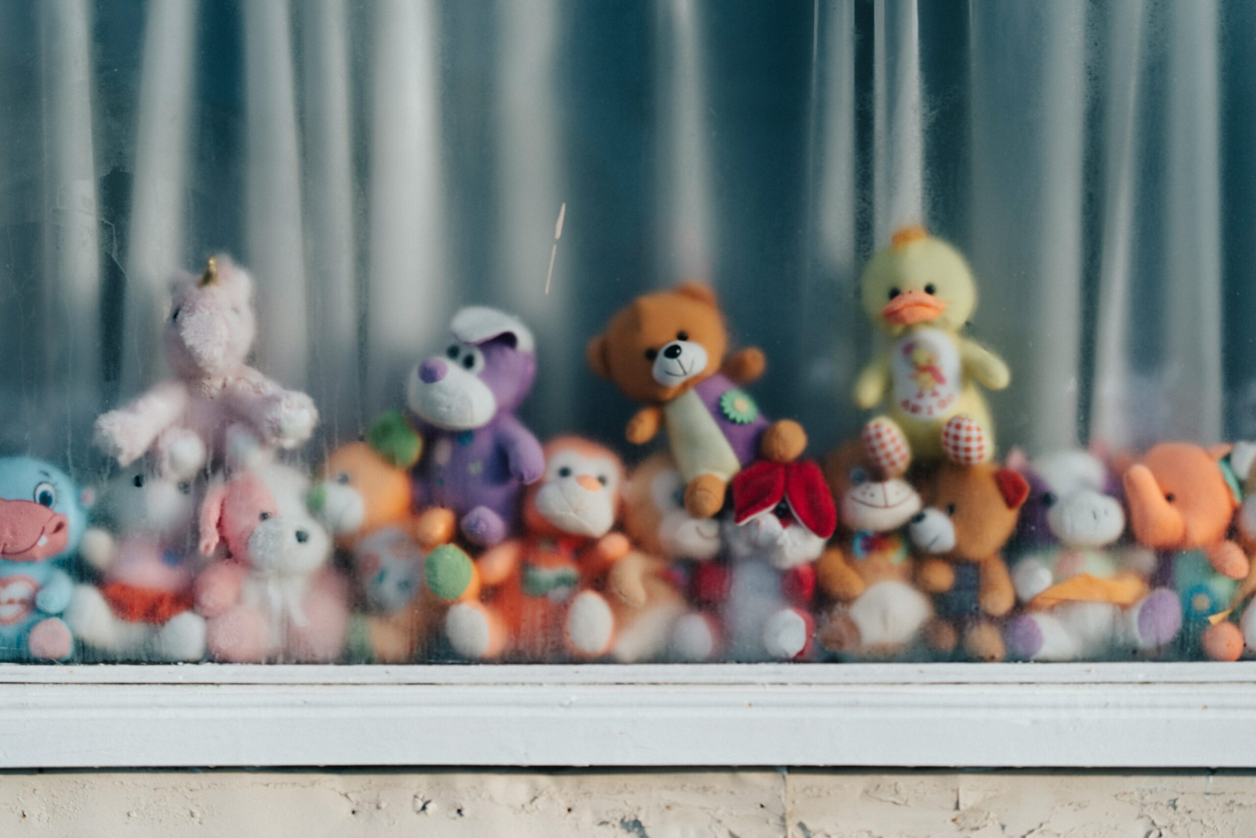 A selection of colorful glass pet toys arranged neatly on a shelf