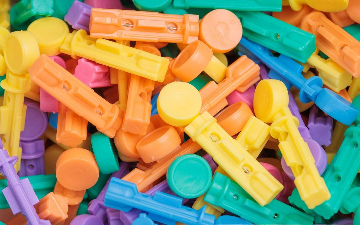 A happy golden retriever holding a glass toy
