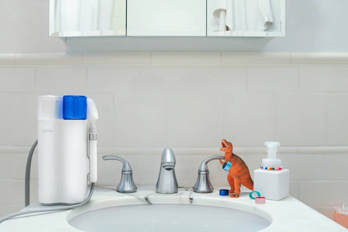 Person carefully washing a glass pet toy in a sink