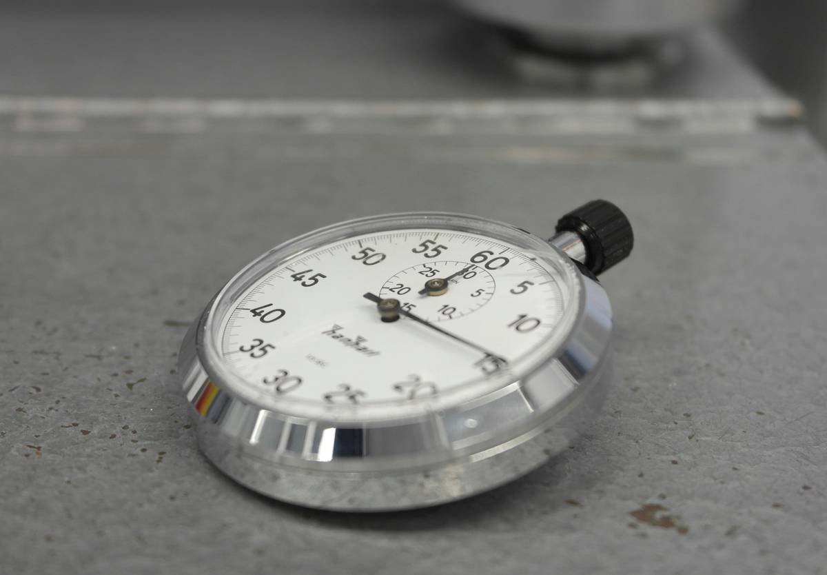 Lab technician performing drop test on borosilicate glass pet toy per ASTM F963-17 standard