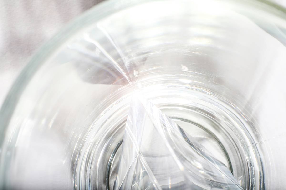 Side-by-side image: left shows a rough-edged, unannealed glass toy with visible stress fractures; right shows a smooth, properly annealed borosilicate pet toy with rounded edges